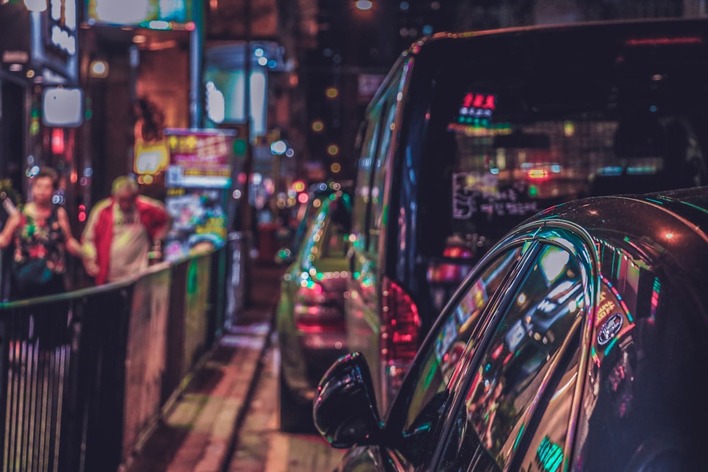 parked vehicles near hand rail at night