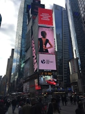 Bright outdoor advertising billboards along a busy city street.