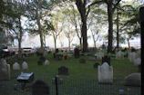 A serene cemetery scene with a modern plaque featuring a QR code on a gravestone.