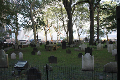 A serene cemetery scene with a modern plaque featuring a QR code on a gravestone.