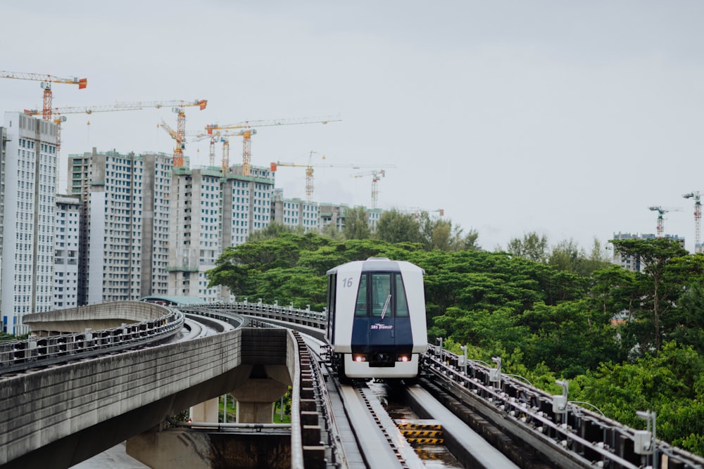 white train on railway during daytime