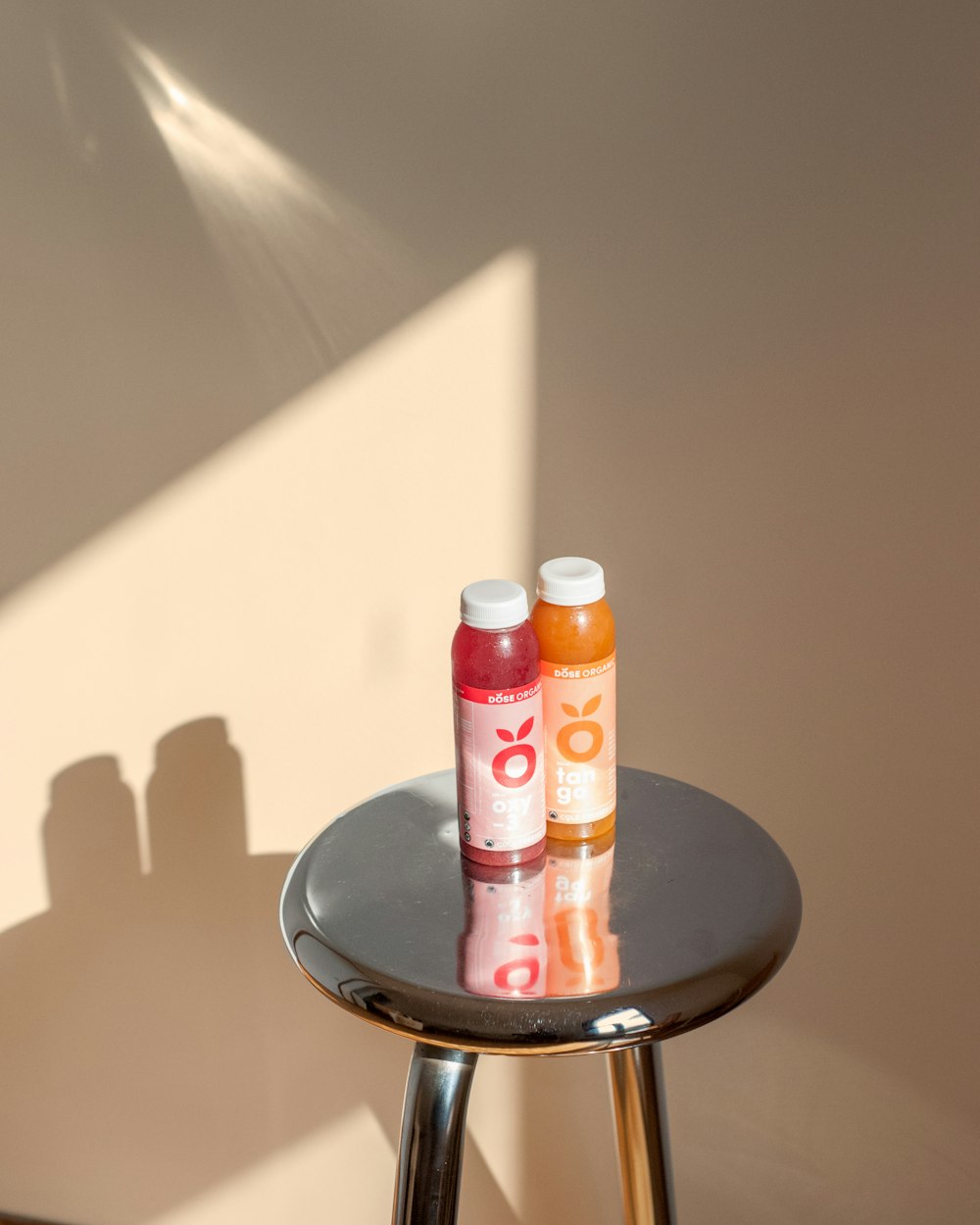 two smoothie bottles on stool