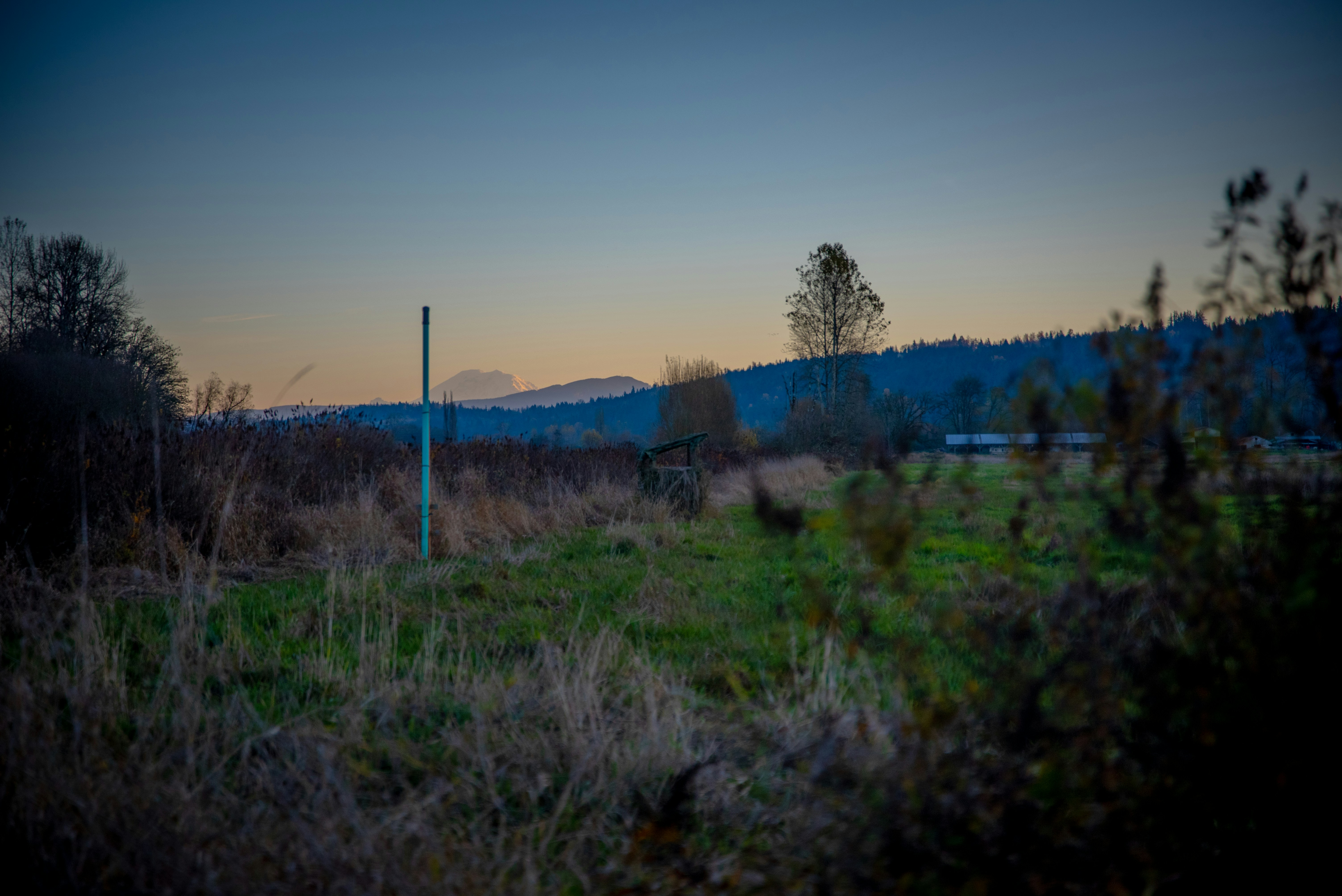 Mountain range at dusk with dramatic orange sky