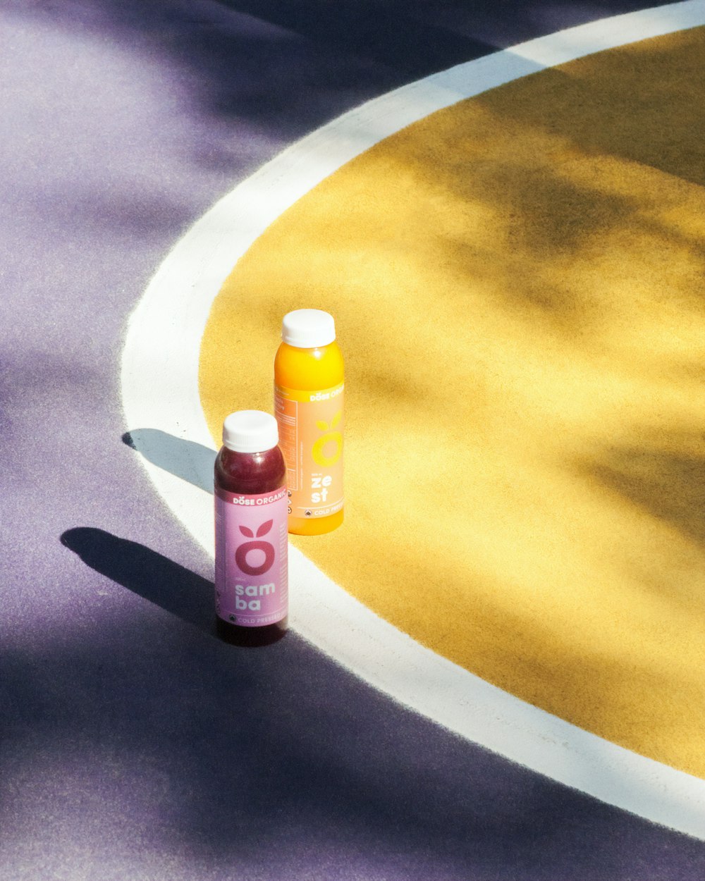 two fruit juice bottles on ground