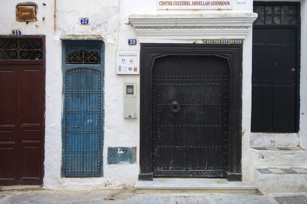 photo of closed black, teal, and maroon gates