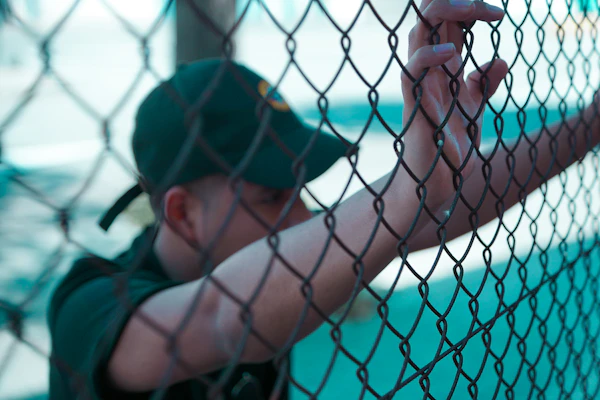 Person wearing a black baseball cap outdoors