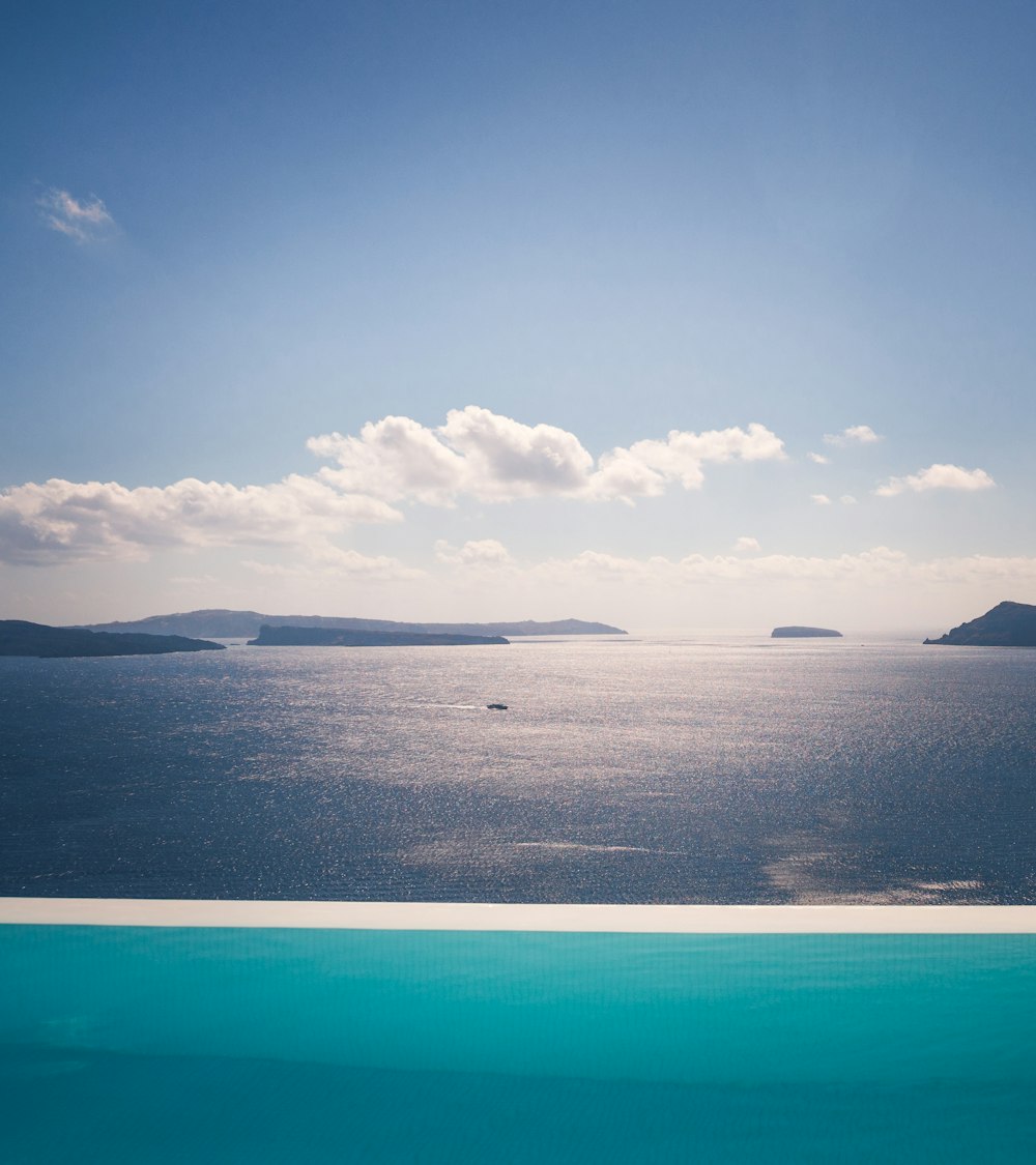 landscape photography of blue ocean under cloudy sky