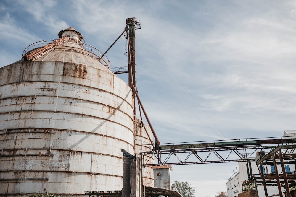 a large metal silo sitting next to a building