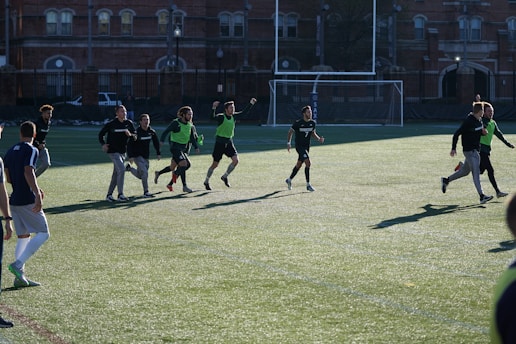 A group of amateur soccer players competing on an outdoor five-a-side football pitch.