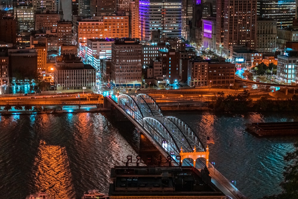 aerial photography of bridge and buildings at night time