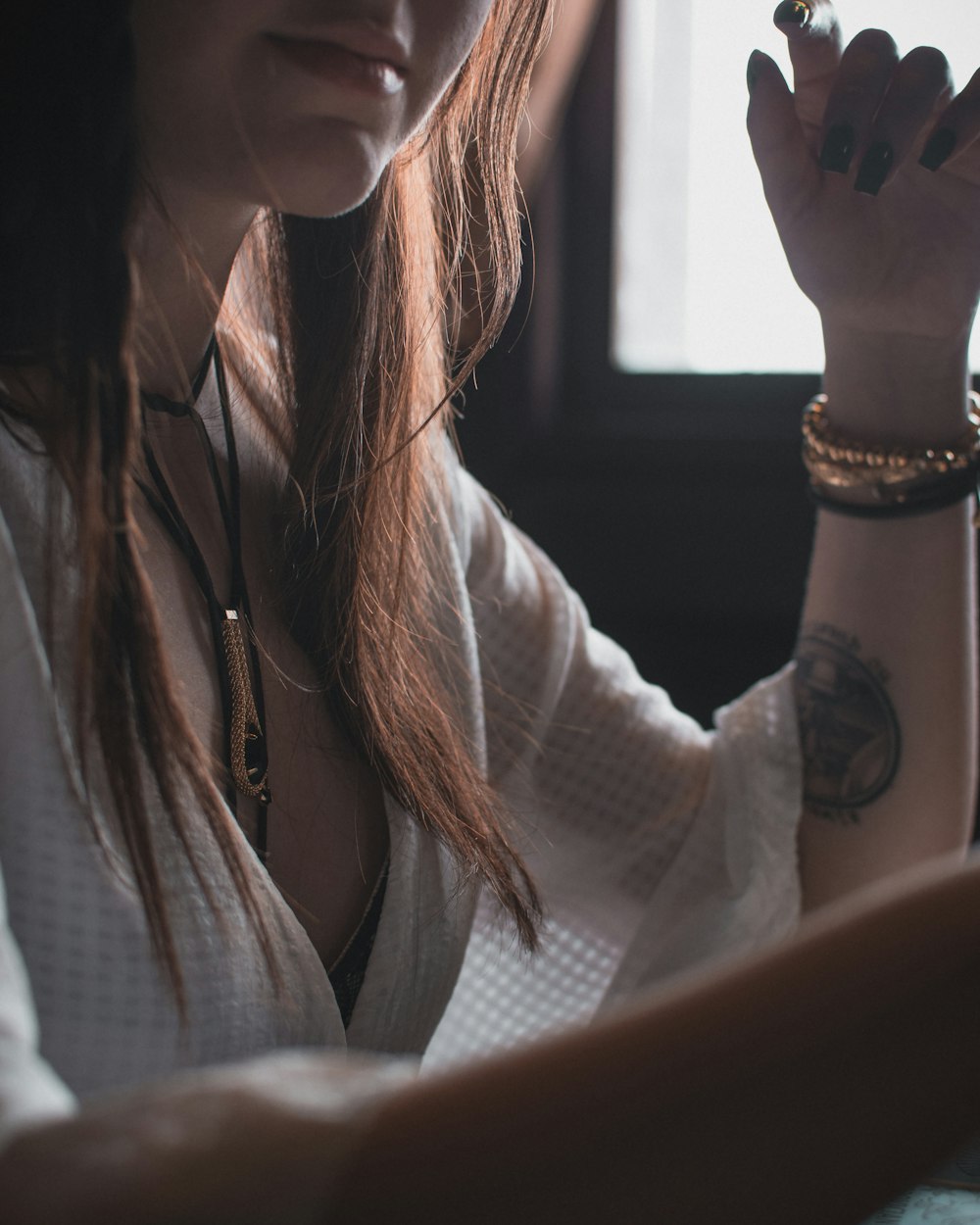 woman wearing white V-neck 3/4-sleeved blouse