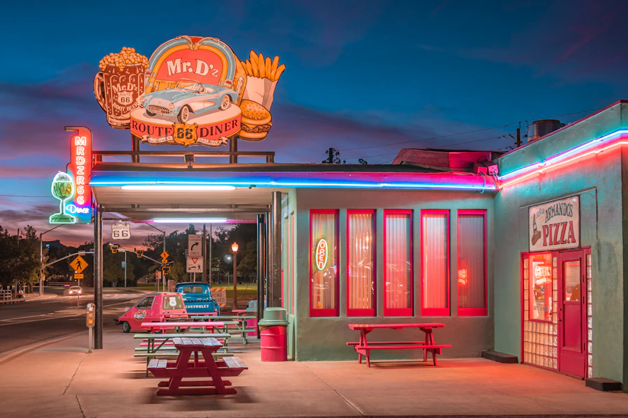 A red vinyl booth and chrome-edged table inside a classic American diner.