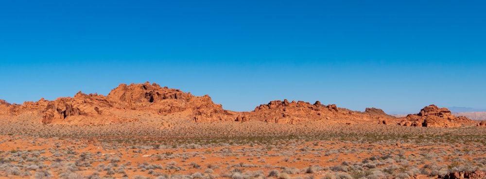 brown rock formation under blue sky