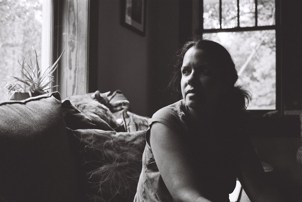 grayscale photography of woman inside room