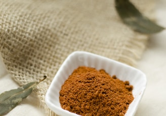 a small white bowl filled with brown powder