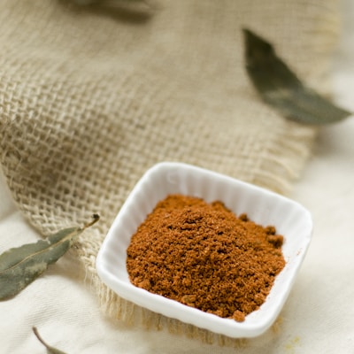 a small white bowl filled with brown powder