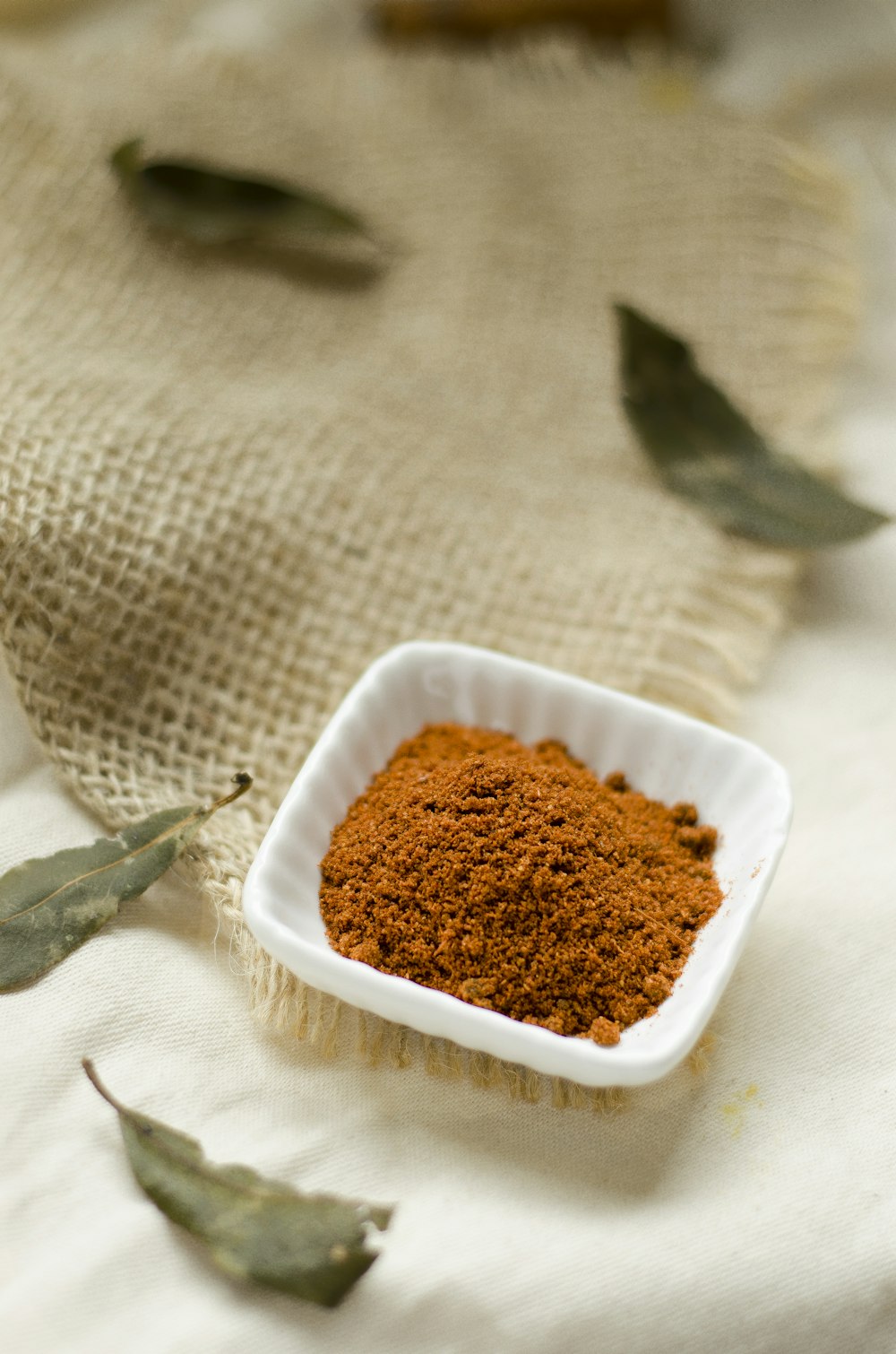 a small white bowl filled with brown powder