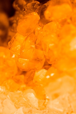Close-up of amber dust particles glowing softly under warm light