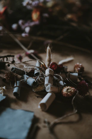 A gentle arrangement of memory jars filled with handwritten notes and tiny keepsakes, illuminated by soft afternoon light.