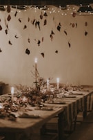 A farmhouse dining table set with simple, charming ceramic dishes and candles.