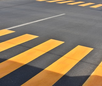gray and yellow concrete roadway at daytime