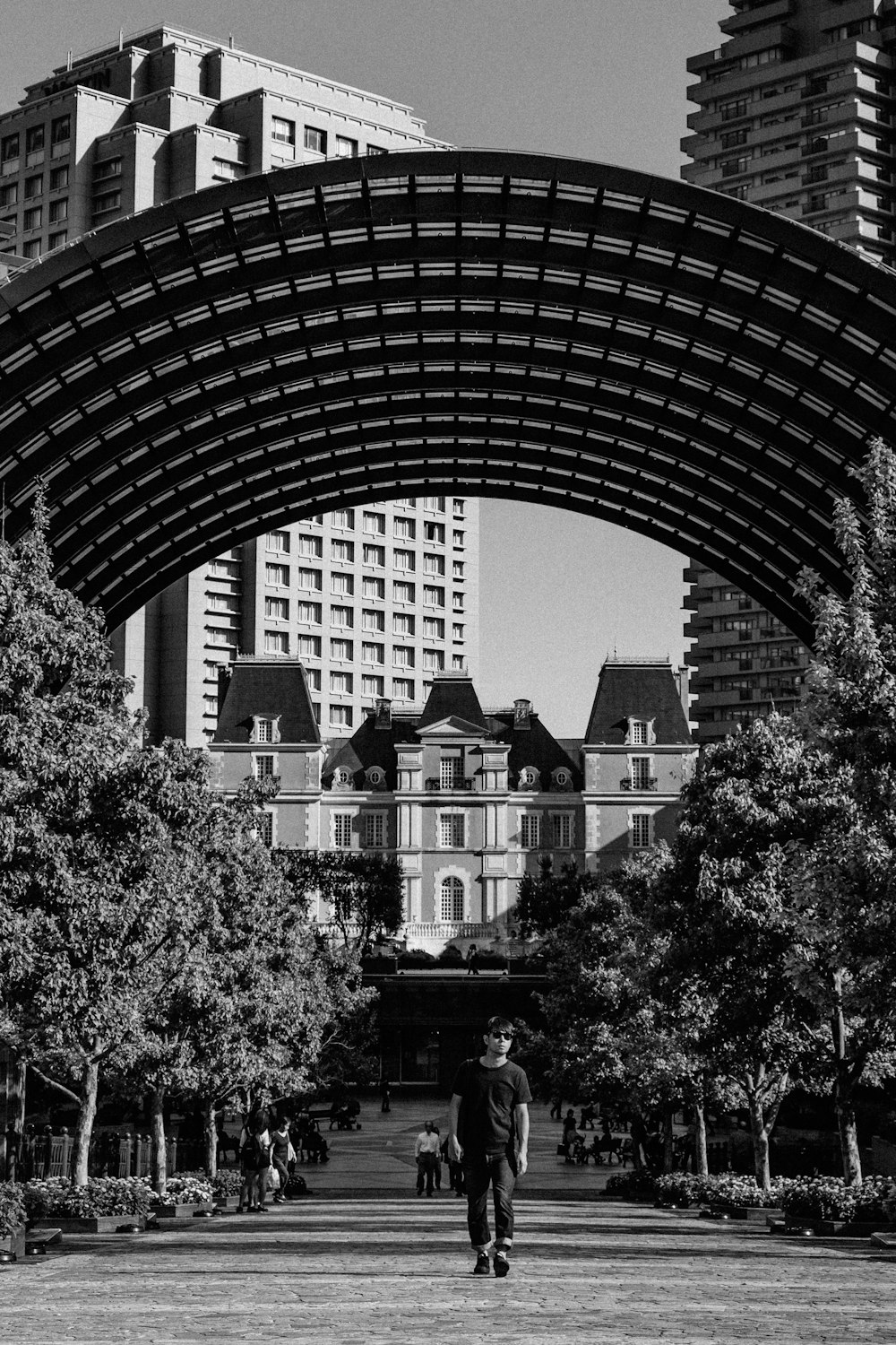 grayscale photography of man standing outdoor