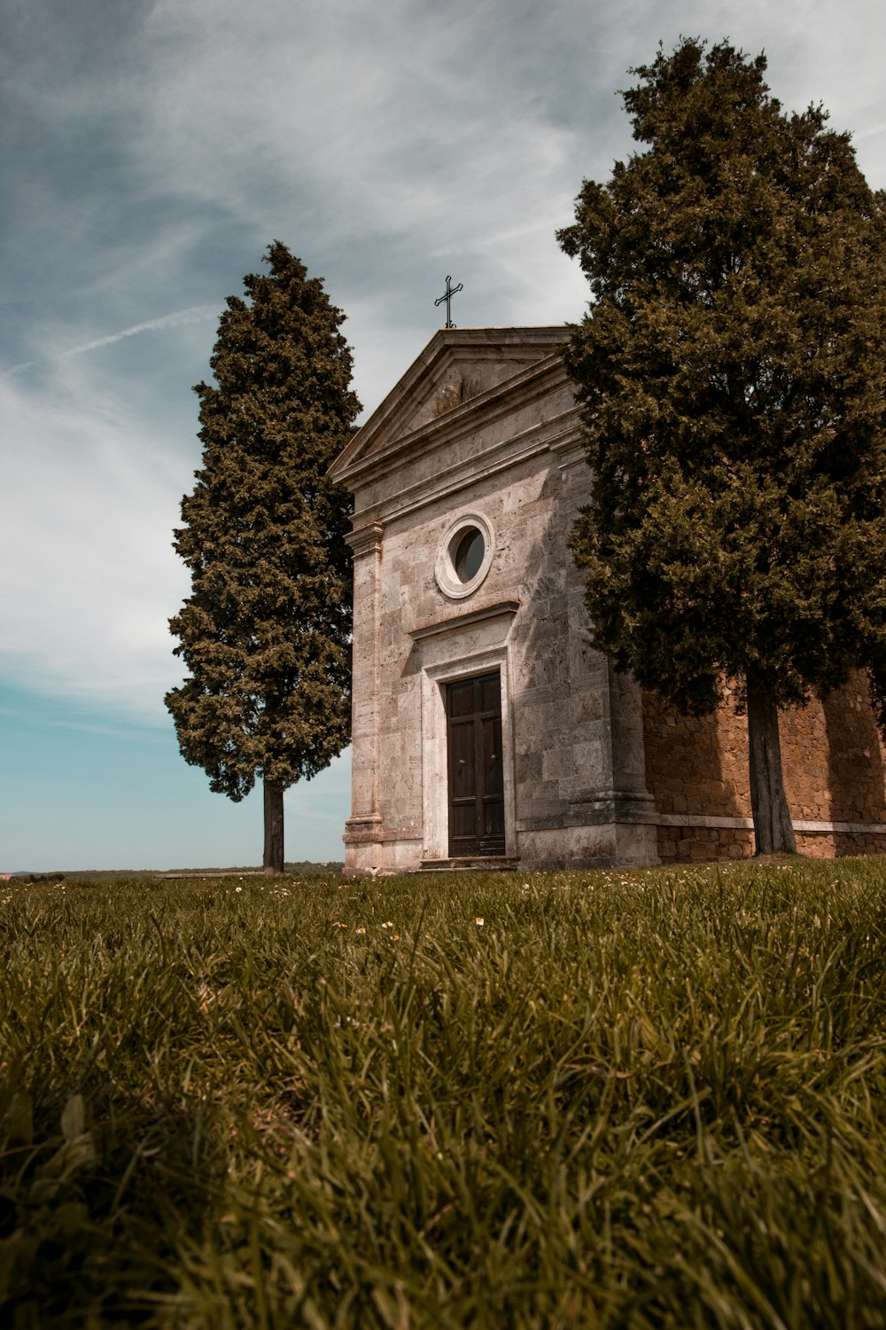 grey concrete church beside trees during daytime