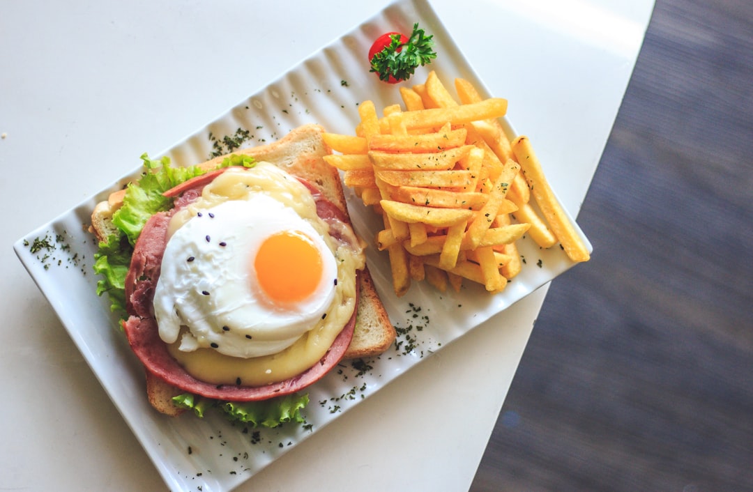bread with egg and fries on plate
