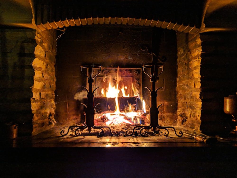 Wood fire burning cleanly in a swept stone fireplace