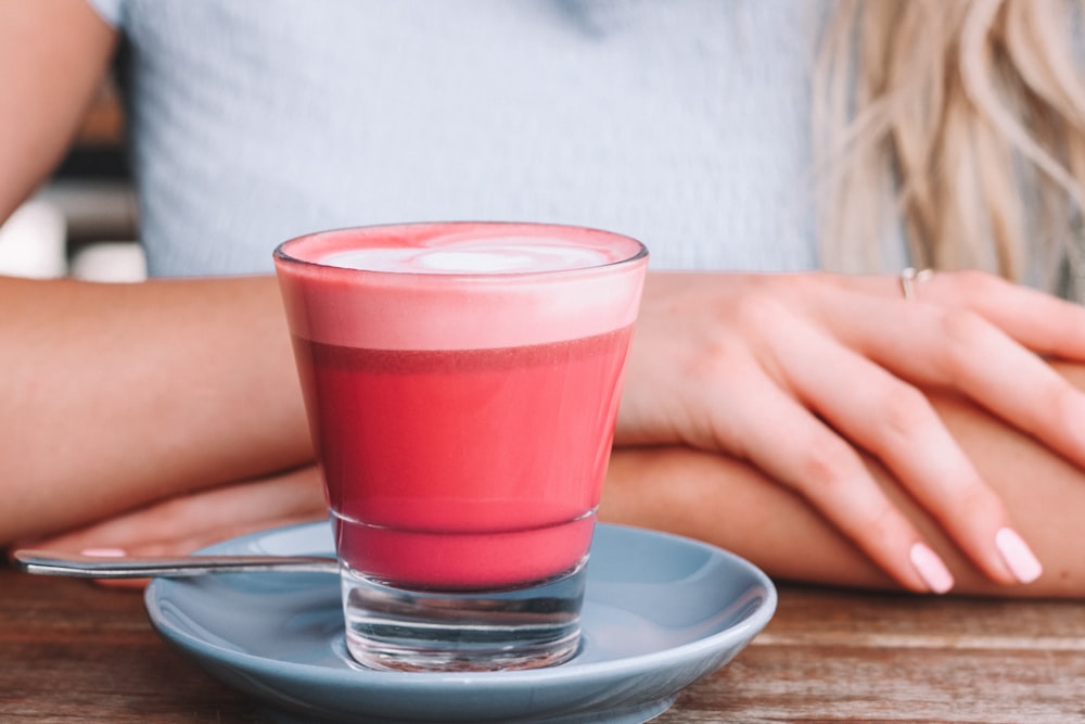 woman in front of drink and saucer