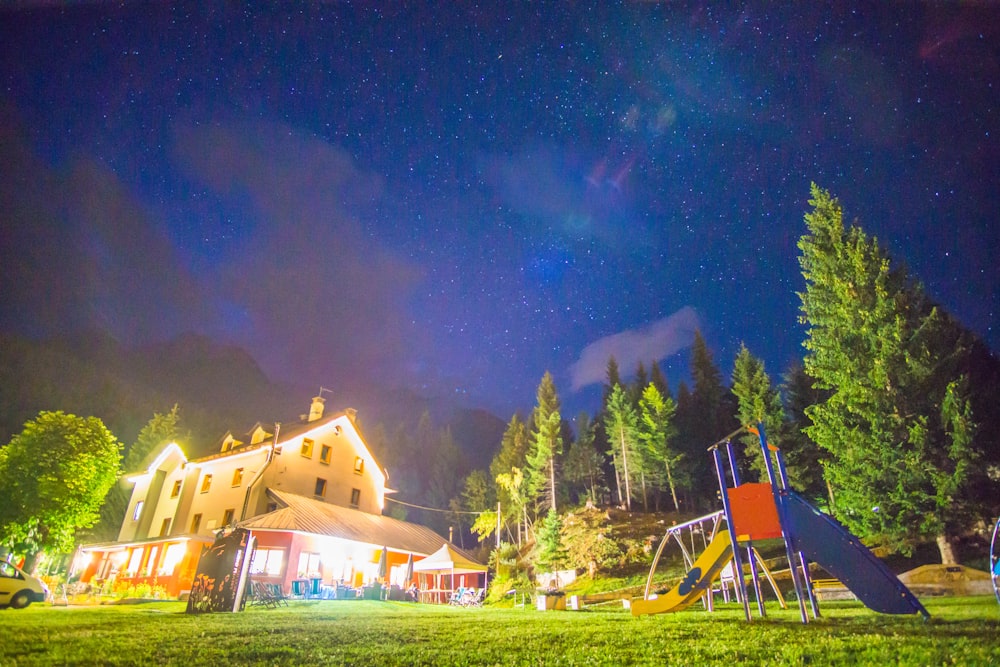 photo of beige and white building surrounded by trees during nighttime