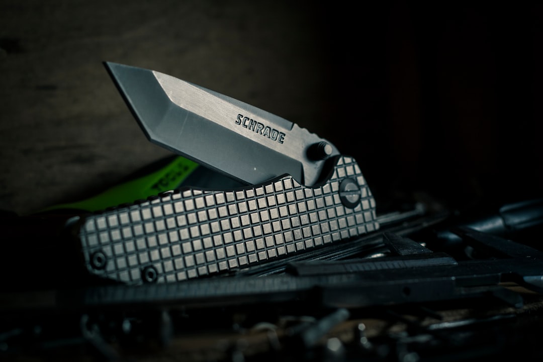 selective focus photography of black pocket knife