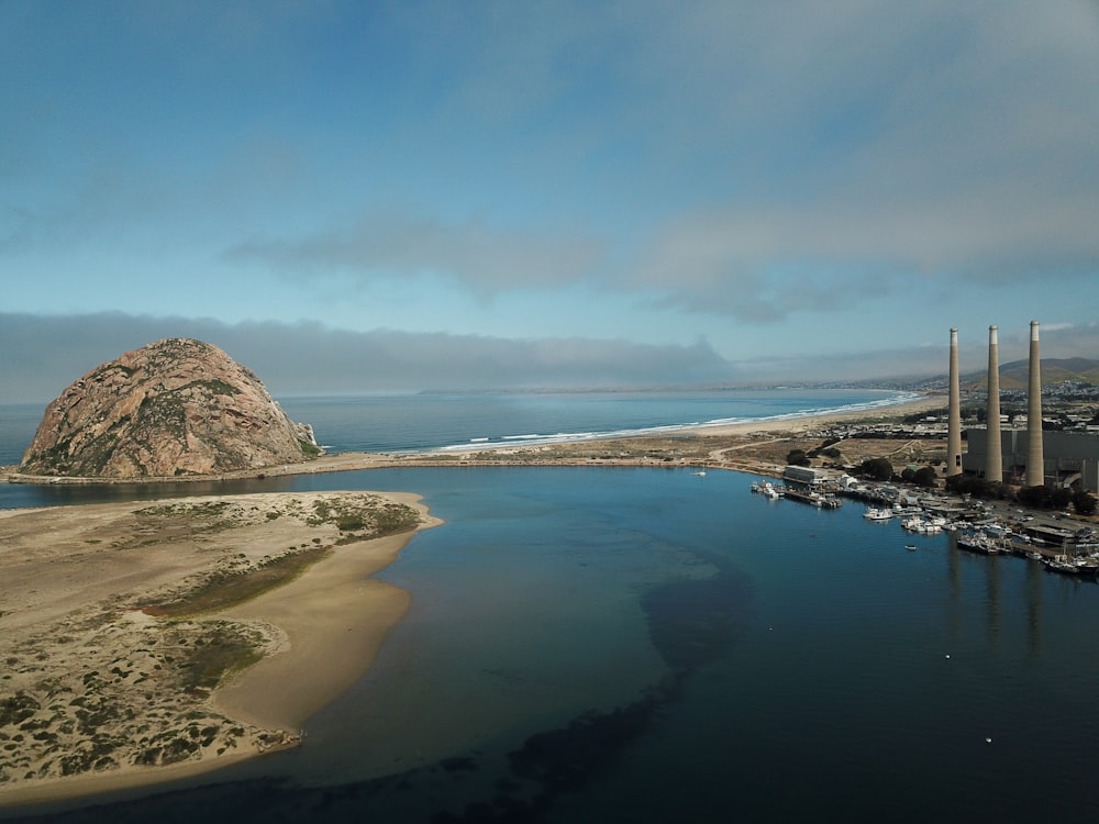 Fotografía aérea de la isla con vistas a la colina y a la plantación bajo las nubes blancas y durante el día