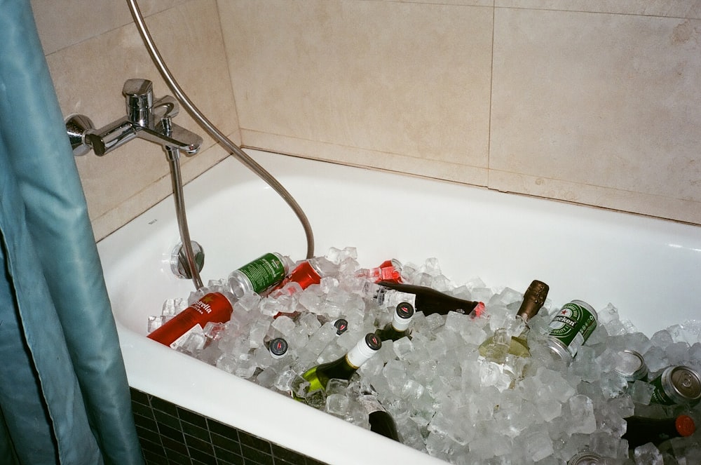 assorted beverage bottle in bathtub