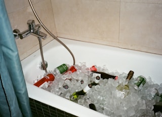 assorted beverage bottle in bathtub