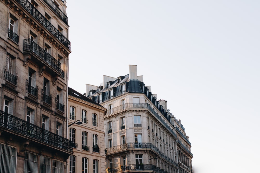 white concrete buildings under white clouds during daytime