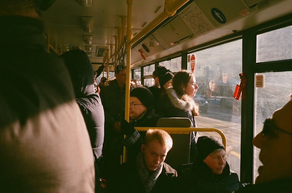 group of people inside the bus during daytime