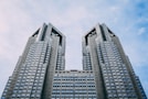 gray high-rise building under white and blue sky