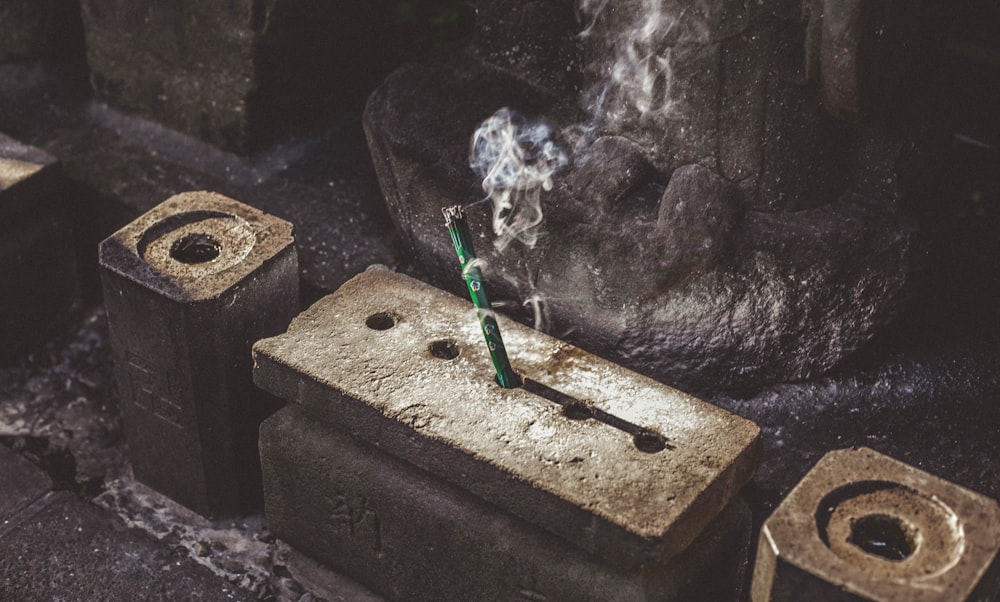 green incense stick on concrete rack