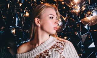 A vibrant sequin sweater sparkling under gentle light, displayed on a stylish mannequin.