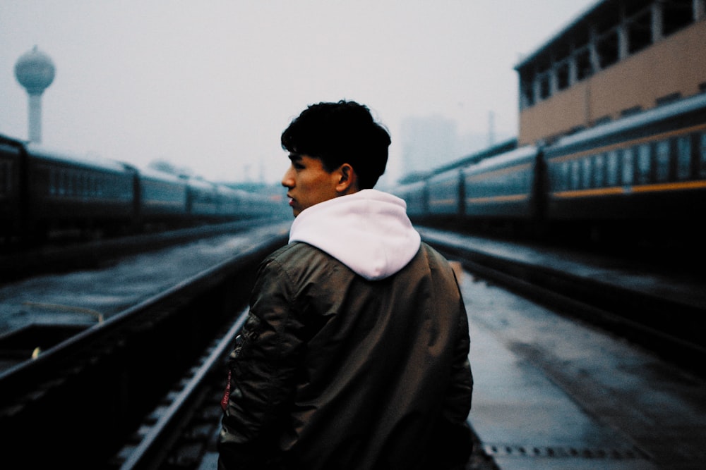 man standing on railway