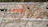 A wall mural features intricate floral and paisley designs with earthy colors like orange and brown. In the foreground, the phrase 'We Love Rishikesh' is painted, with 'Love' styled as a heart symbol. The background is a textured gray wall.
