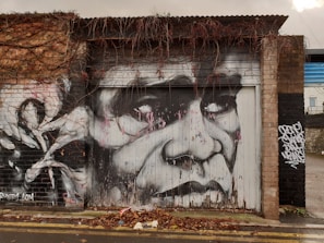 Detail of a graffiti-style mural on the garage wall featuring urban street art elements.