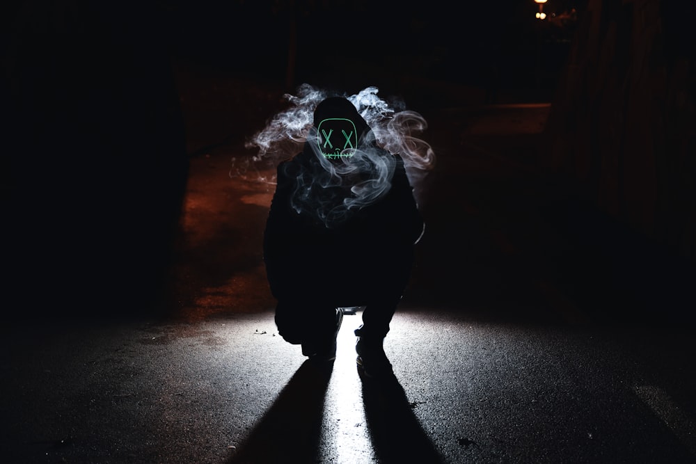 silhouette photo of man with neon mask