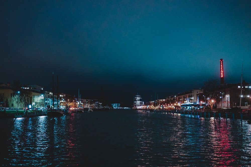 river in between buildings during nighttime