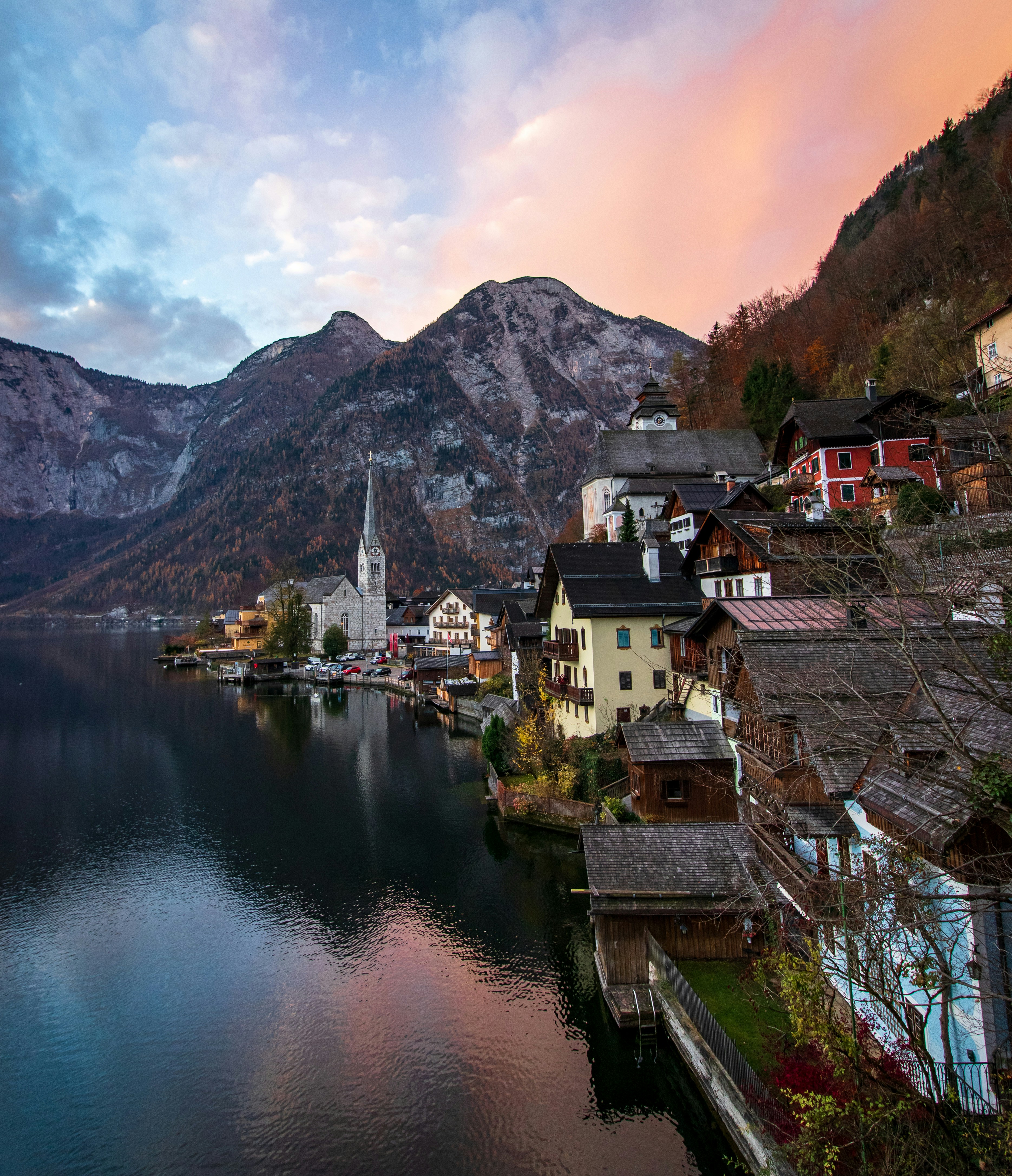 aerial photography of houses in front of body of water overlooking mountain at daytime