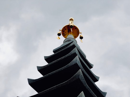 temple with gold tower under gray sky in Naksansa South Korea