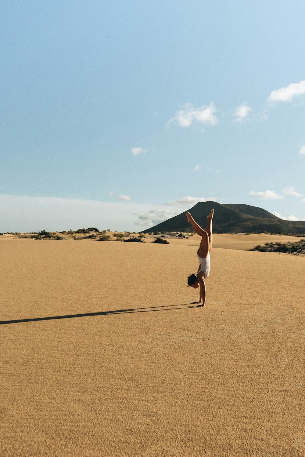 woman meditating on desert