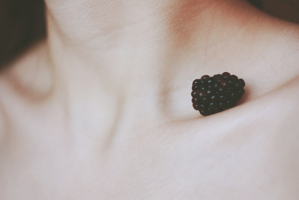 black berry on person's collar bone