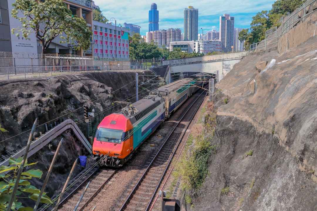 green and red train near buildings